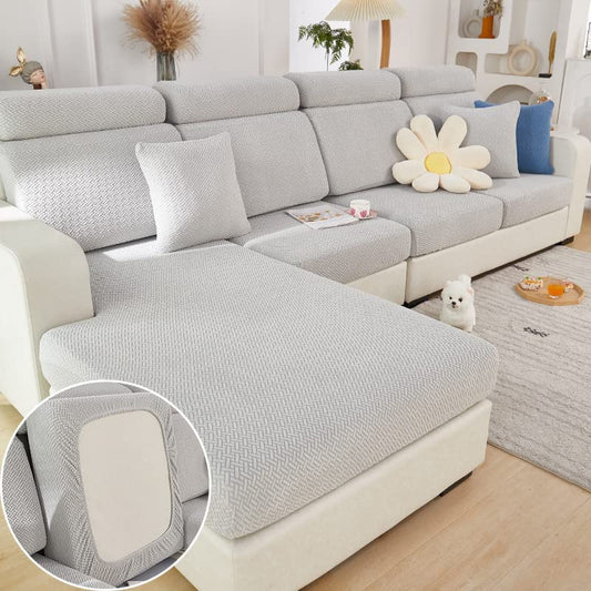 A set of Grey Decorelation Couch Covers on a chaise sofa in a living room.